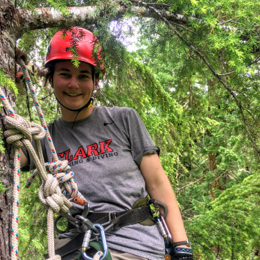 Amanda climbing a tree